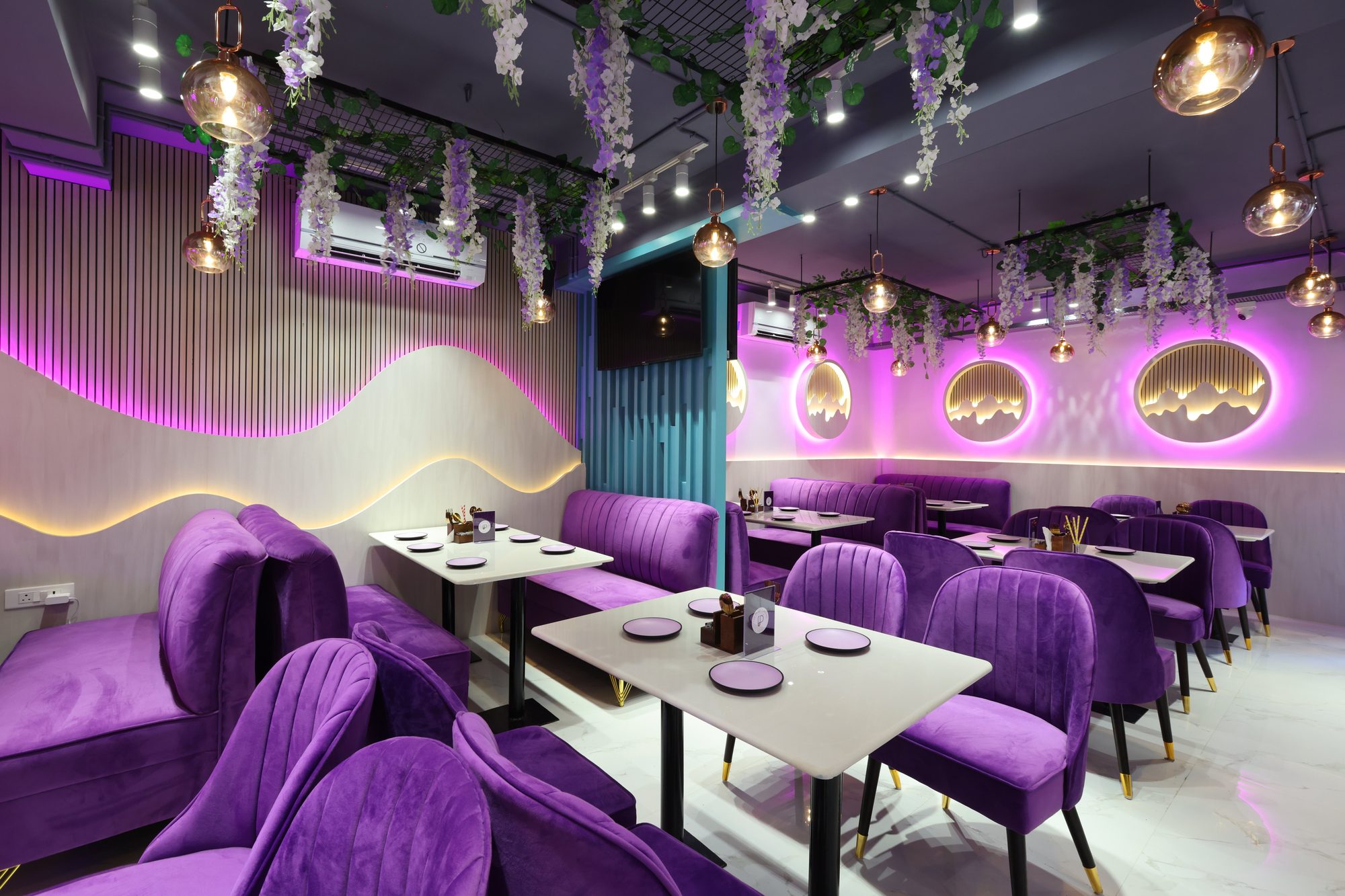 Purple velvet booths and backlit wall art at The Purple Blend, Salt Lake